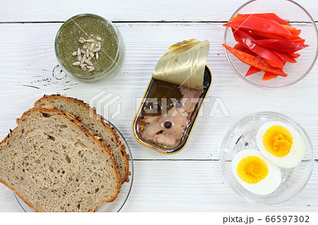 Cod liver in a tin  on white table, flat lay 66597302