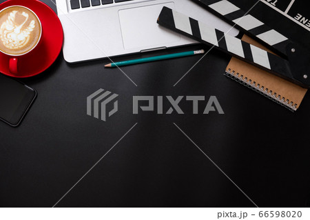 office stuff with Movie clapper, laptop, smartphone, tablet, coffee cup, pen, notepad and documents on the wood table top view shot. office stuff with Movie clapper, laptop, smartphone, tablet, coffee cup, pen, notepad and documents on the wood table top view shot. 66598020