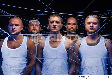Photo of group of men tangled in white threads in ultraviolet 66598921