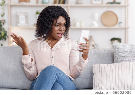 Angry Black Woman Shouting On Cellphone, Having Phone Quarrel At Home 66602086