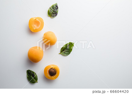 Close-up of ripe peaches on the table. Ripe peaches with leaves Close-up of ripe peaches on the table. Ripe peaches with leaves 66604420