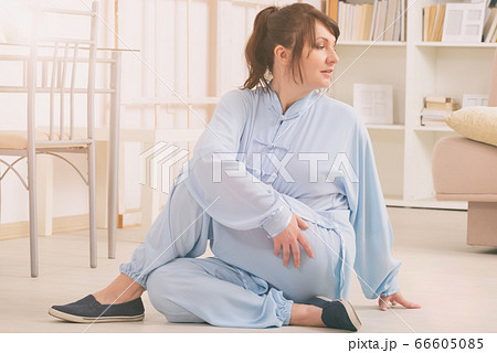 Woman doing qi gong tai chi exercise 66605085