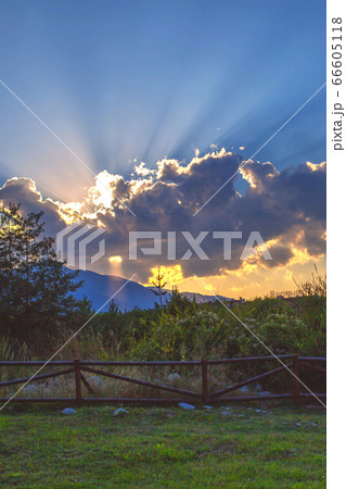 Powerful sun rays beaming through the clouds Powerful sun rays beaming through the clouds 66605118