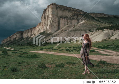 attractive young woman outdoors with stone attractive young woman outdoors with stone 66606352