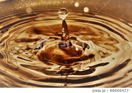 Close up of golden water droplets splashing Close up of golden water droplets splashing 66606427