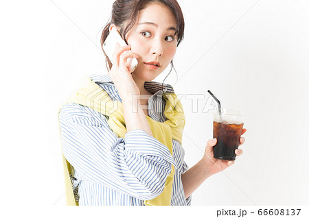 電話をするオフィスカジュアルの女性 66608137