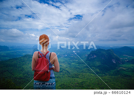 Happy hiker with her arms outstretched, freedom 66610124