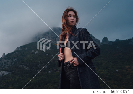 Asian woman in a gray coat enjoying the view in Asian woman in a gray coat enjoying the view in 66610854