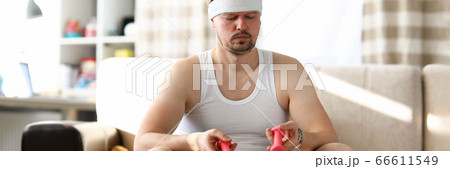 Young man sitting in an apartment on fitness ball 66611549