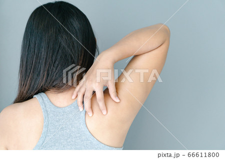 Closeup woman hand holding shoulder with pain on 66611800