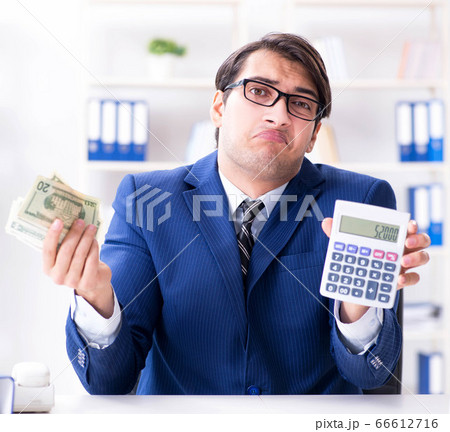Accountant calculating dollars with calculator in office 66612716