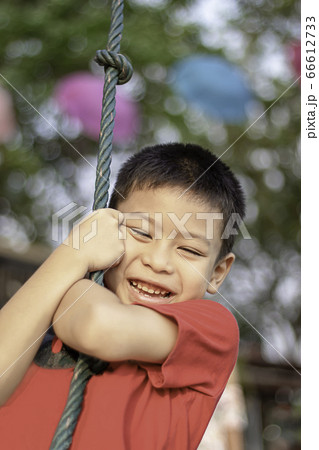 Asean boy at the nodes the rope and smiling happily. 66612733
