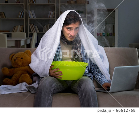 Sick man doing inhalation at night in home 66612769