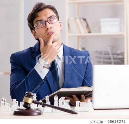 Young lawyer playing chess to train his court strategy and tacti 66613271