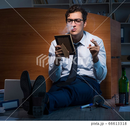 Sad employee in office missing his wife after divorce separation 66613318