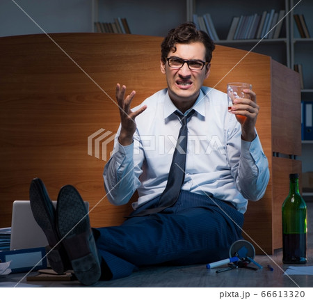 Stressed businessman working overtime in depression 66613320