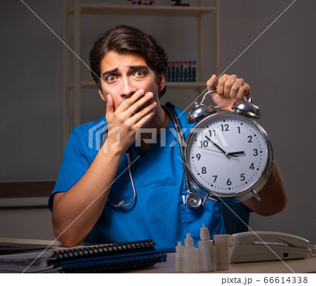 Young handsome doctor working night shift in hospital 66614338