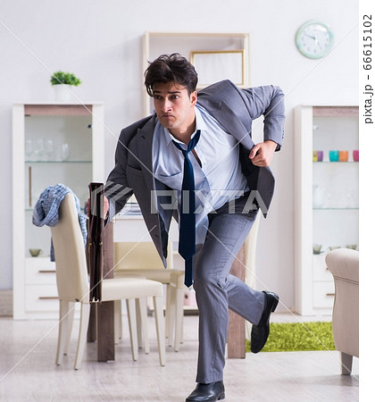 Businessman late for office due to oversleeping after overnight 66615102