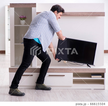 Man trying to fix broken tv Man trying to fix broken tv 66615504