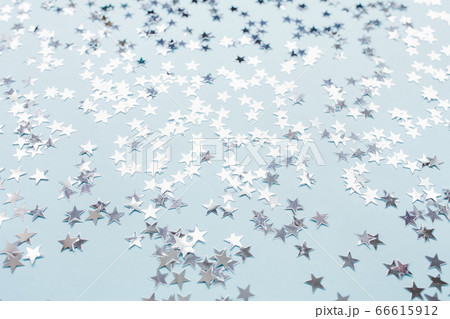 Silver foil confetti stars on blue background Silver foil confetti stars on blue background 66615912