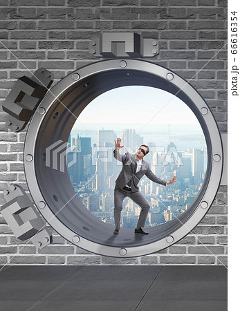 Blindfolded businessman in front ot vault door Blindfolded businessman in front ot vault door 66616354