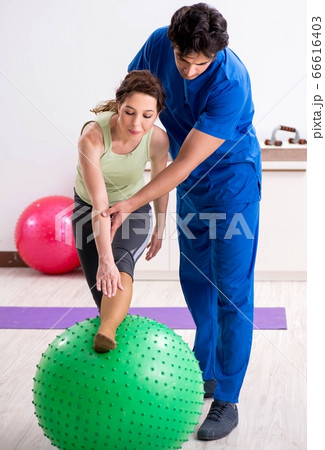 Fitness instructor helping sportsman during exercise Fitness instructor helping sportsman during exercise 66616403