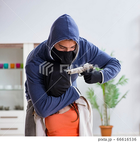 Armed man assaulting young woman at home Armed man assaulting young woman at home 66616536