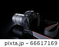 Professional digital SLR photo camera with a zoom lens and a leather strap on a black background with copy space. Top angle view. Realistic 3d render. Place for advertising text. Reflection at bottom 66617169