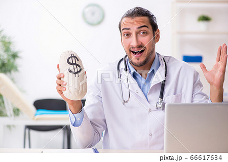 Young handsome male doctor working in the clinic Young handsome male doctor working in the clinic 66617634