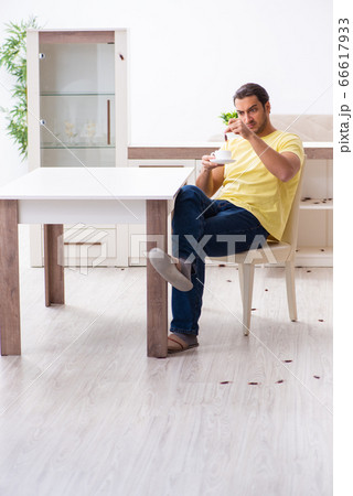 Young man and a lot of cockroaches at home 66617933