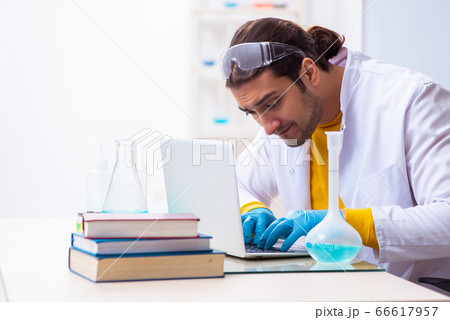 Young male chemist student preparing for exam 66617957