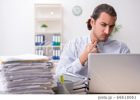 Young male businessman employee unhappy with excessive work 66618061