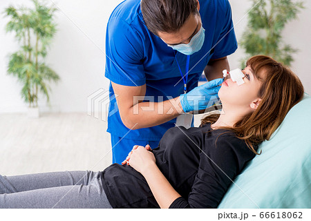 Young beautiful woman visiting doctor in plastic surgery concept Young beautiful woman visiting doctor in plastic surgery concept 66618062
