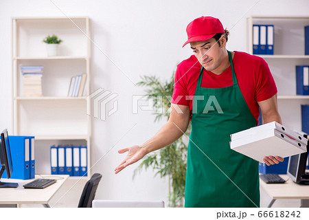 Young male courier delivering pizza to the office Young male courier delivering pizza to the office 66618242