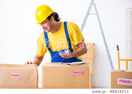 Young male professional mover doing home relocation Young male professional mover doing home relocation 66618253