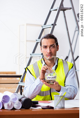 Young male architect working indoors Young male architect working indoors 66618262