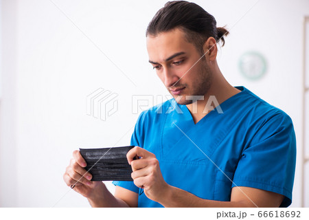 Young male doctor working in the clinic Young male doctor working in the clinic 66618692
