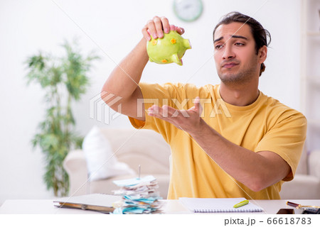 Young man in budget planning concept Young man in budget planning concept 66618783