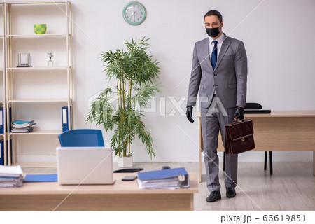 Young male employee in the office during pandemic disease Young male employee in the office during pandemic disease 66619851
