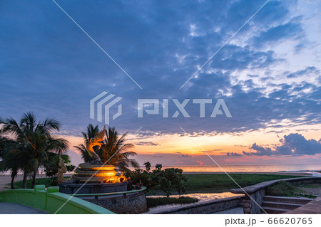 .sunset at golden dragon statue on Karon beach 66620765
