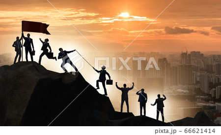 Concept of teamwork with team climbing mountain top Concept of teamwork with team climbing mountain top 66621414