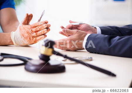 Male doctor in courthouse meeting with advocate 66622063