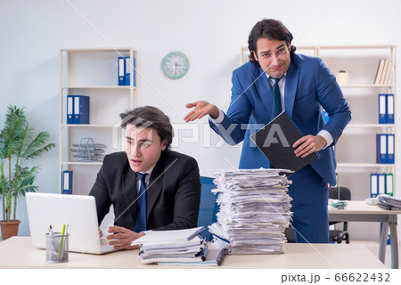 Two male colleagues unhappy with excessive work Two male colleagues unhappy with excessive work 66622432