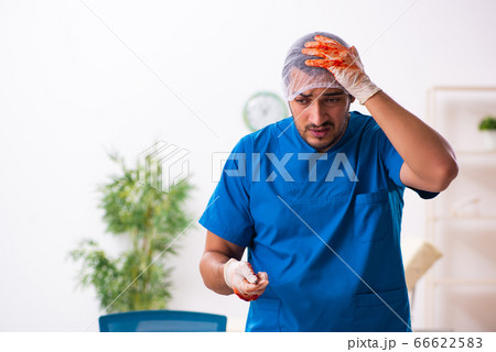 Young male doctor surgeon in fatal negligence concept 66622583