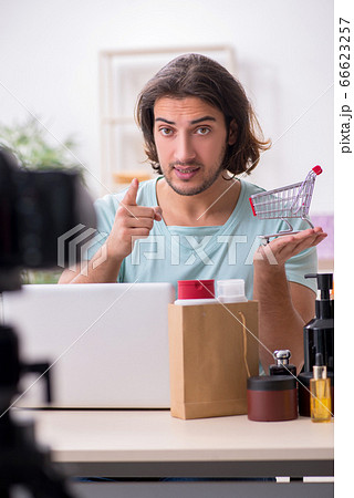 Young male shopaholic recording video for his blog Young male shopaholic recording video for his blog 66623257