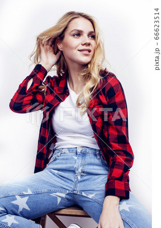 young pretty teenage hipster girl posing emotional happy smiling on white background, lifestyle people concept 66623514