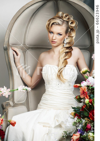 beauty young bride alone in luxury vintage interior with a lot of flowers, makeup and creative hairstyle 66623946