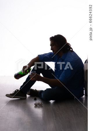 Young man suffering from alcoholism 66624392