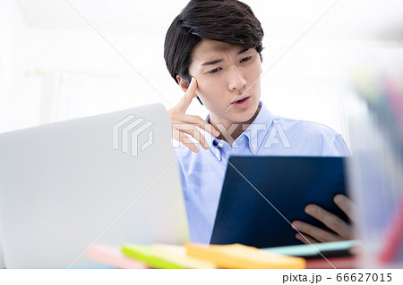 自宅で仕事をする若い男性 自宅で仕事をする若い男性 66627015