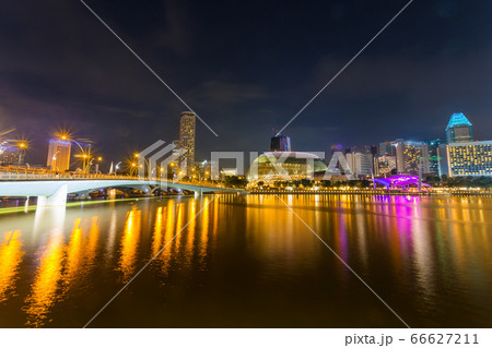 Cityscape of Singapore skyline at night time. Marina Bay is a bay located in the Central Area of Singapore 66627211
